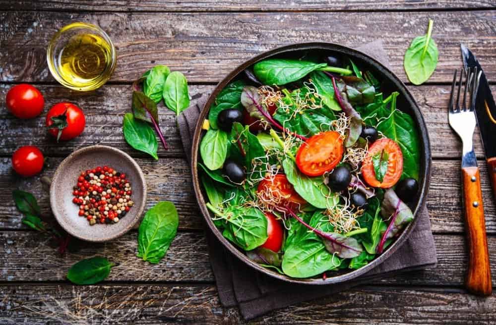 Salad in a bowl on a wooden table.