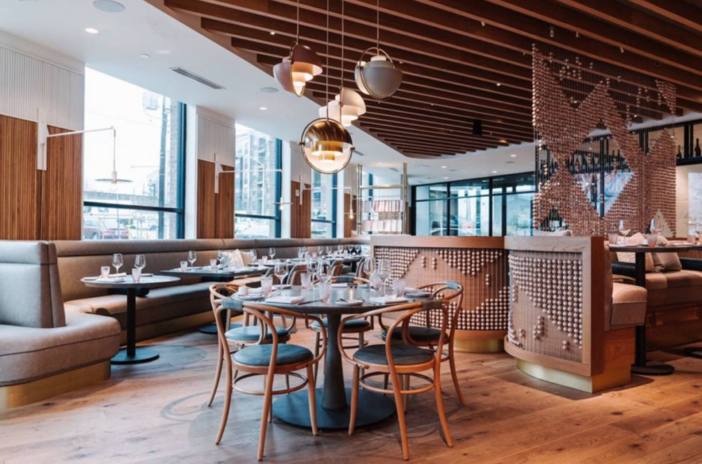 The interior of a restaurant with wooden tables and chairs.